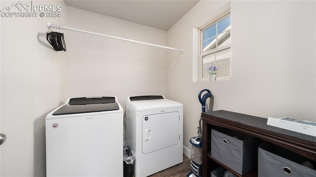 washroom with dark wood-type flooring and independent washer and dryer