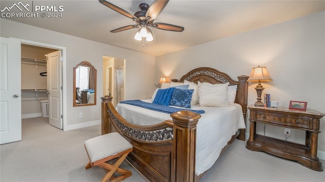 carpeted bedroom featuring a spacious closet, a closet, and ceiling fan