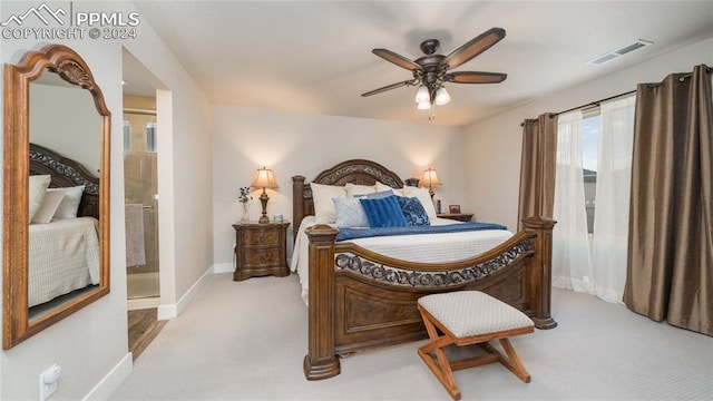 carpeted bedroom with connected bathroom and ceiling fan