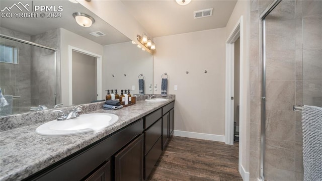 bathroom featuring vanity, an enclosed shower, and hardwood / wood-style floors