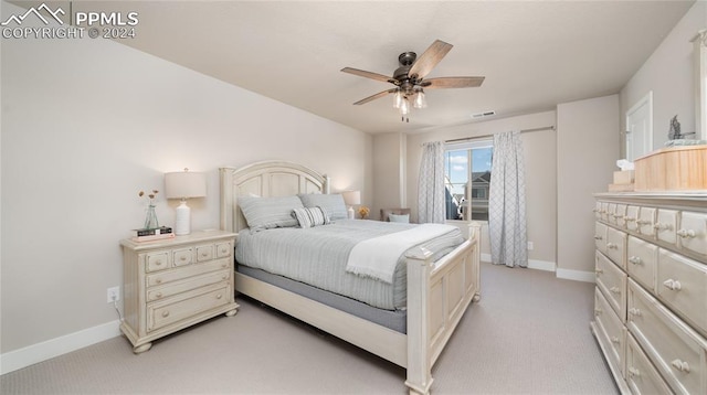 bedroom featuring ceiling fan and light carpet