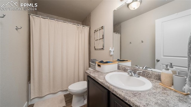 bathroom with vanity, hardwood / wood-style floors, and toilet