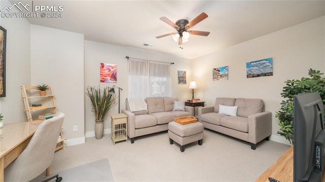 carpeted living room featuring ceiling fan