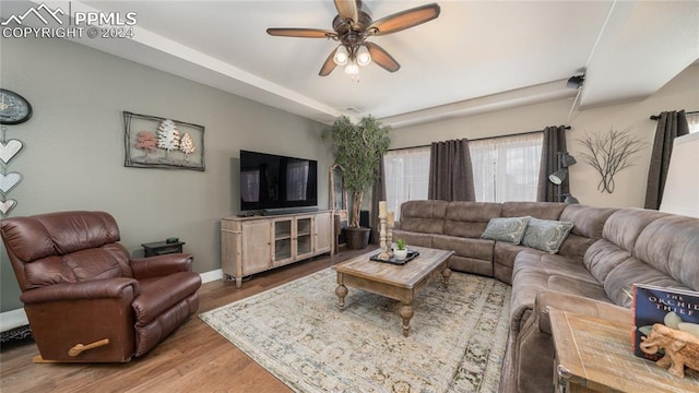 living room with hardwood / wood-style flooring and ceiling fan