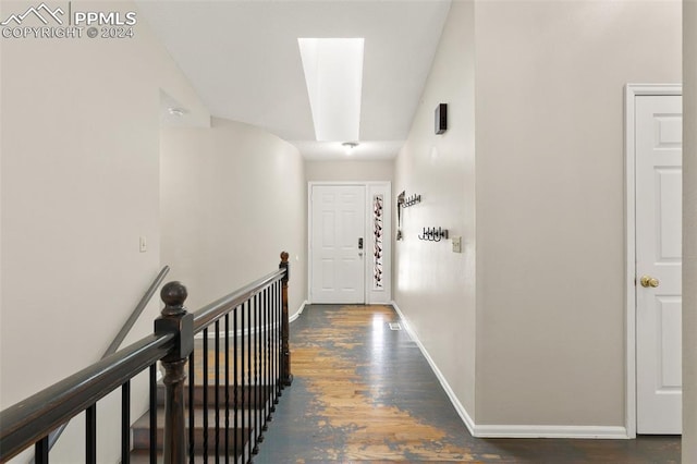 corridor featuring a skylight and dark wood-type flooring