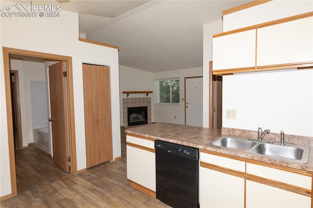 kitchen with white cabinetry, dishwasher, sink, and a textured ceiling