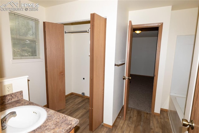 bathroom with vanity, hardwood / wood-style floors, and shower / bath combination