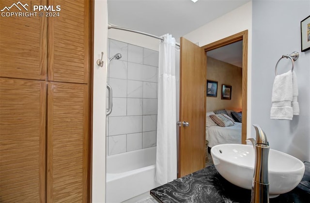 bathroom with sink and shower / bath combination with curtain