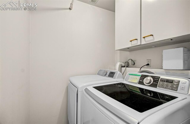 laundry area featuring cabinets and separate washer and dryer