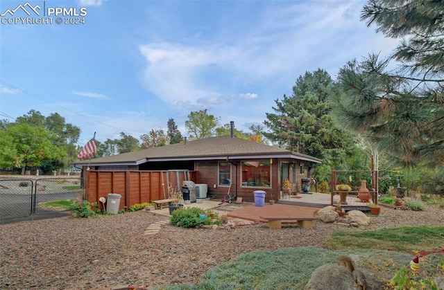 rear view of property featuring a deck