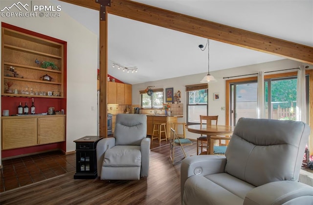 living room featuring built in features, dark wood-type flooring, and vaulted ceiling with beams