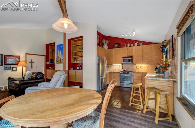 dining space featuring lofted ceiling and dark hardwood / wood-style flooring