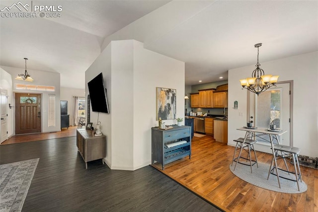 interior space with an inviting chandelier and dark hardwood / wood-style flooring