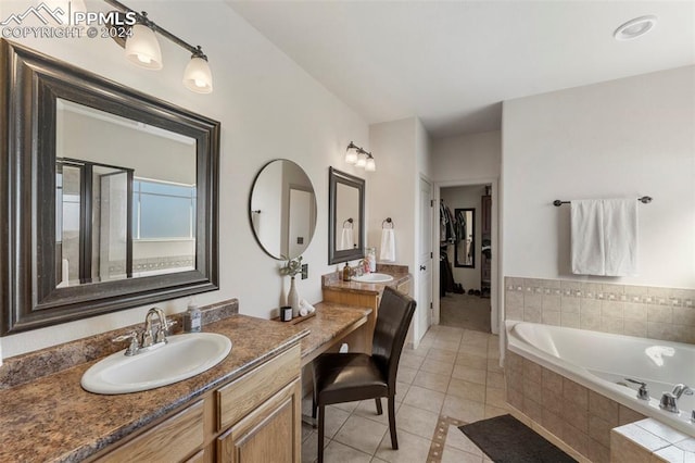 bathroom featuring vanity, shower with separate bathtub, and tile patterned flooring