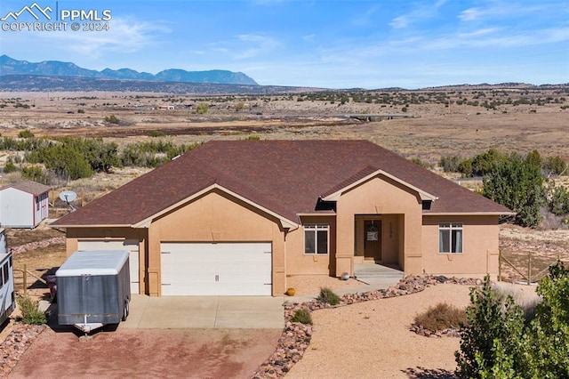 ranch-style home featuring a mountain view and a garage