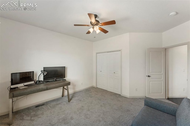 home office with light carpet and ceiling fan