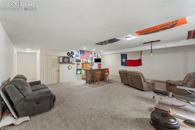 living room featuring carpet flooring, a textured ceiling, and bar area