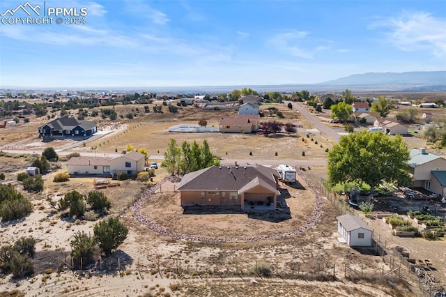 birds eye view of property featuring a mountain view