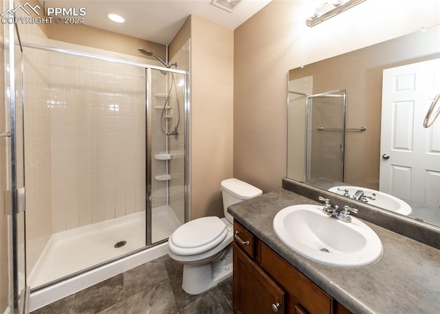 bathroom with walk in shower, vanity, and toilet