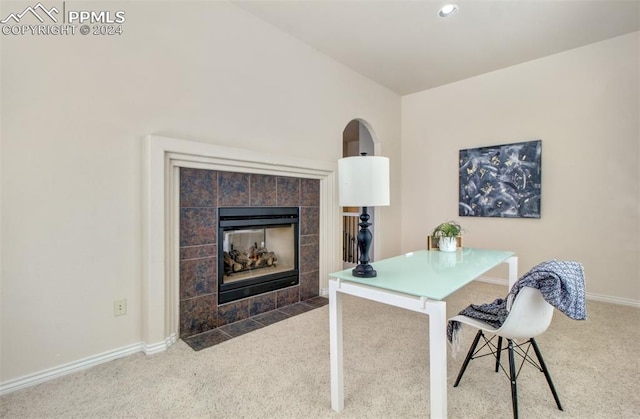 home office featuring carpet flooring and a tiled fireplace