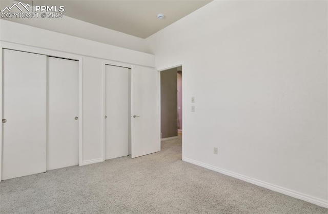 unfurnished bedroom with light colored carpet