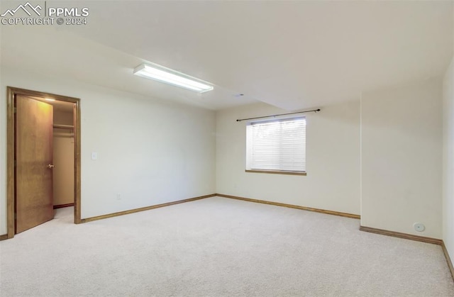 unfurnished room with light carpet