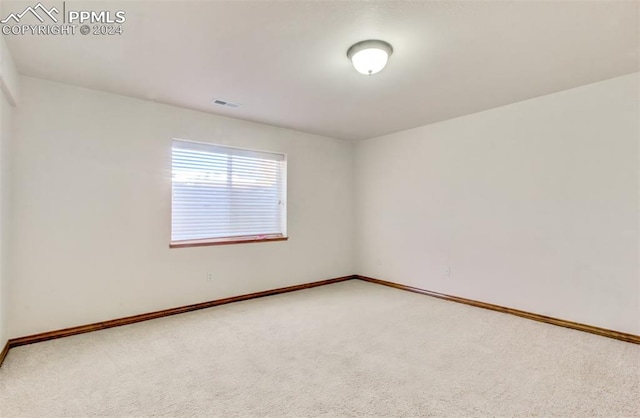 unfurnished room with carpet flooring