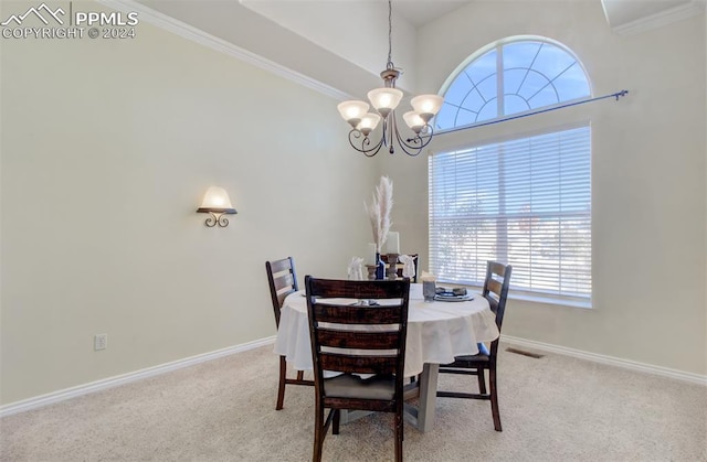 dining area featuring light colored carpet, an inviting chandelier, and ornamental molding