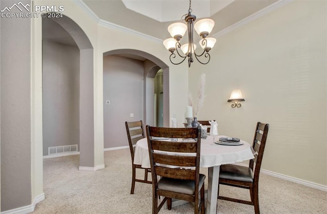 dining area featuring an inviting chandelier, carpet floors, and ornamental molding