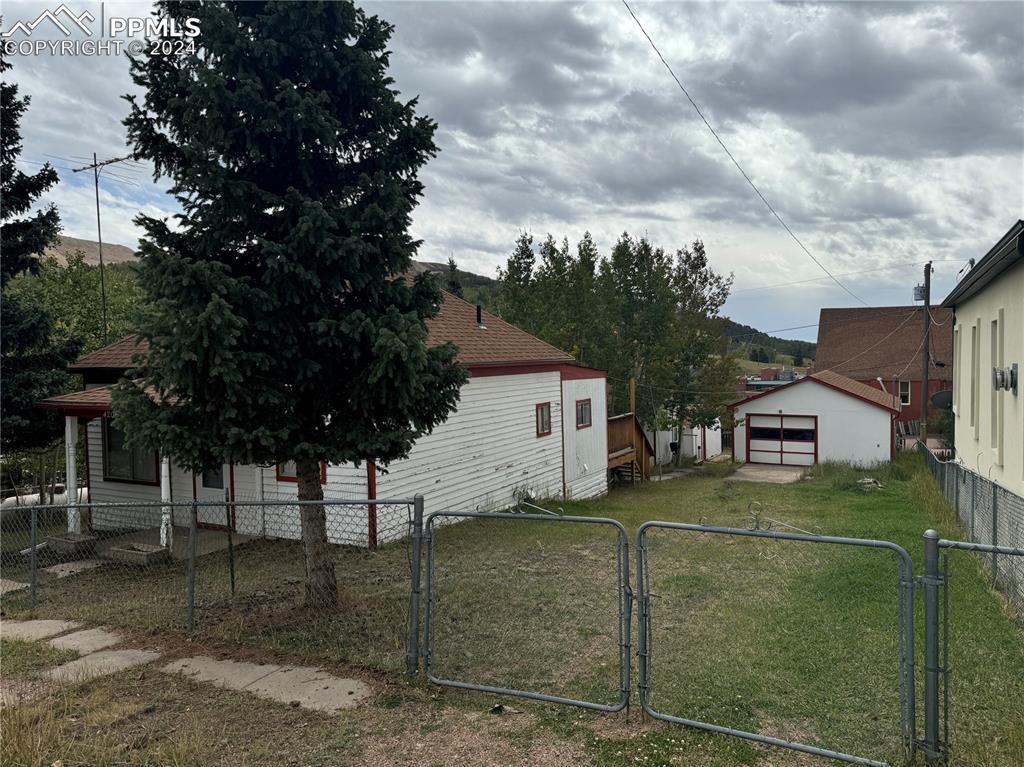 view of property exterior with an outbuilding and a yard