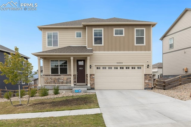 view of front of home with covered porch and a garage