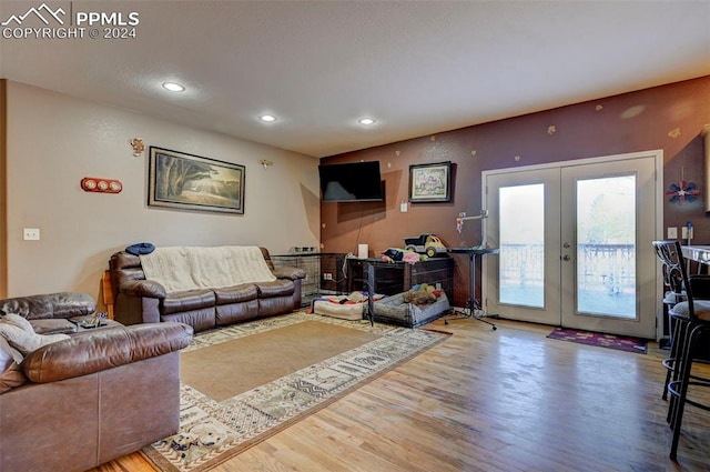 living room featuring wood-type flooring and french doors