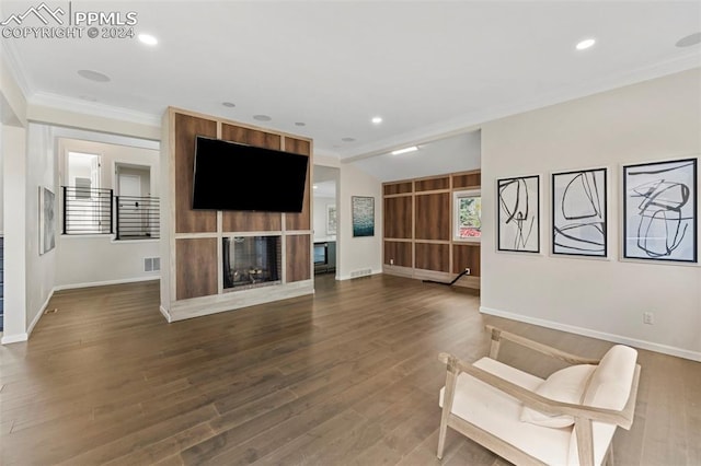 unfurnished room with dark wood-type flooring, crown molding, and a fireplace