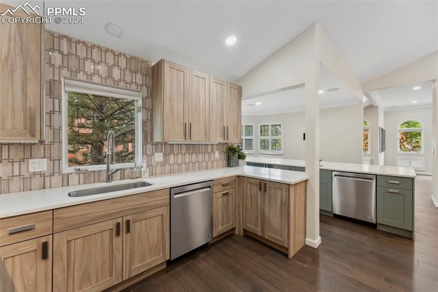 kitchen with kitchen peninsula, stainless steel dishwasher, sink, and vaulted ceiling