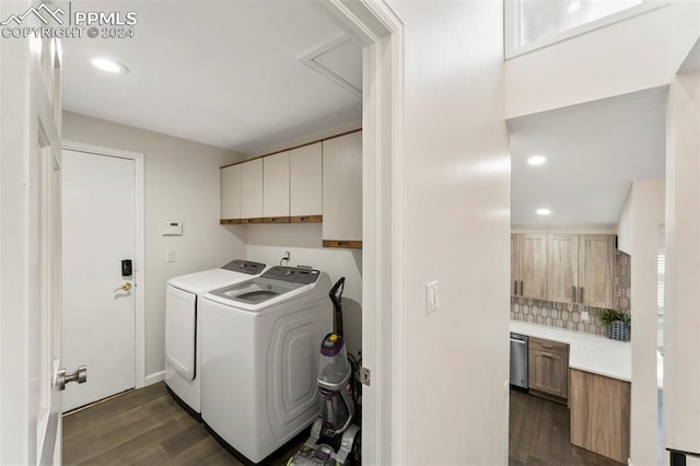 washroom featuring cabinets, independent washer and dryer, and dark wood-type flooring