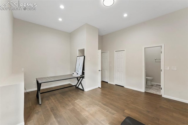 interior space with dark wood-type flooring and a high ceiling