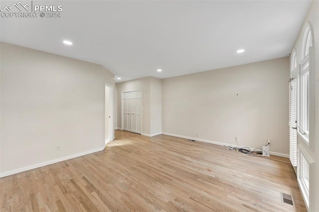 spare room with light hardwood / wood-style floors