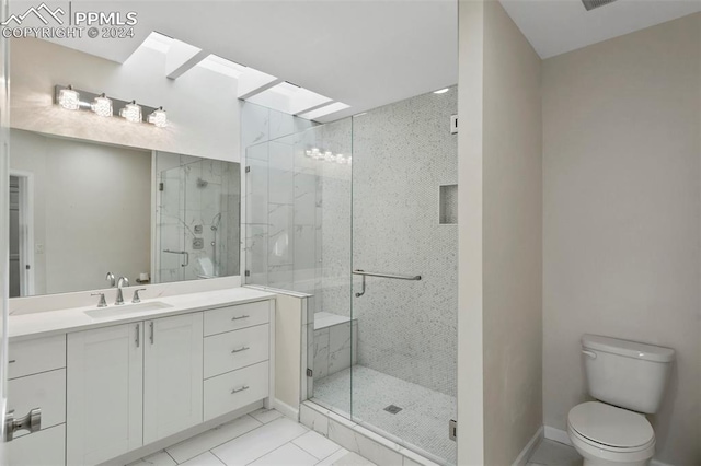 bathroom featuring a shower with door, a skylight, toilet, tile patterned floors, and vanity