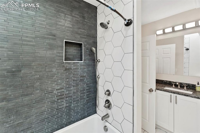 bathroom featuring vanity and tiled shower / bath combo