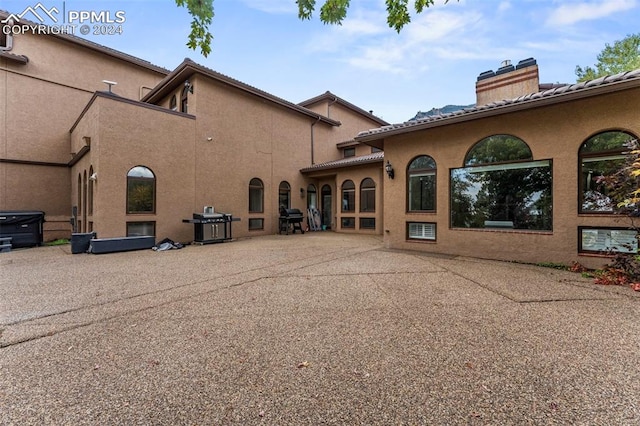 back of house with a patio