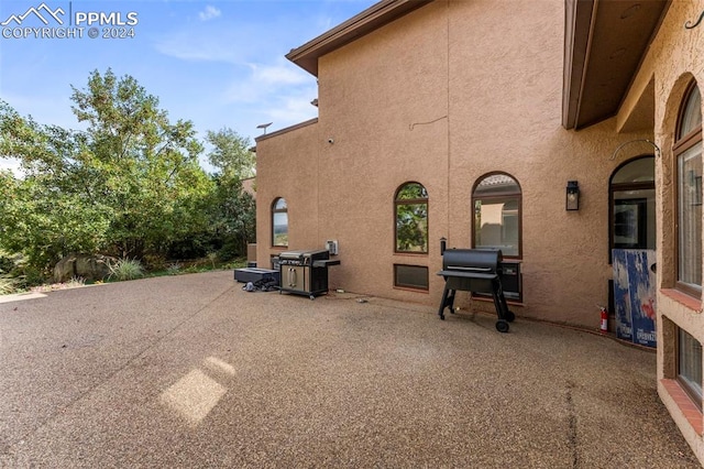 view of side of home featuring a patio