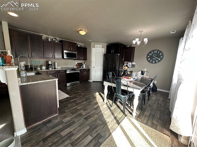 kitchen featuring dark hardwood / wood-style floors, dark brown cabinets, sink, a chandelier, and appliances with stainless steel finishes