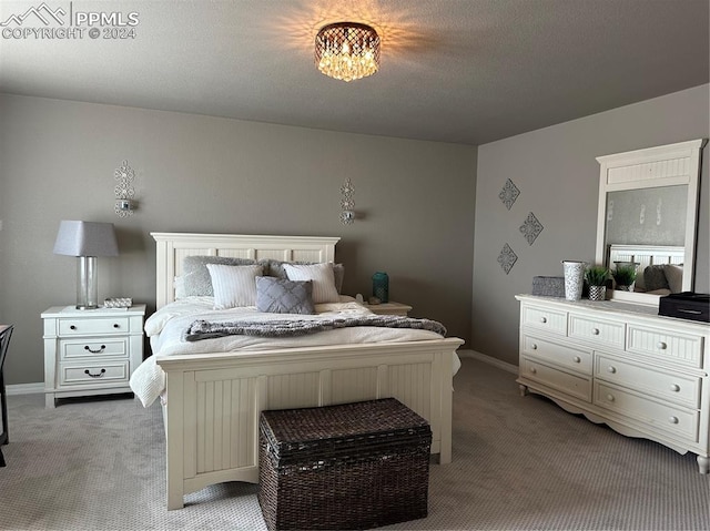 carpeted bedroom featuring a textured ceiling