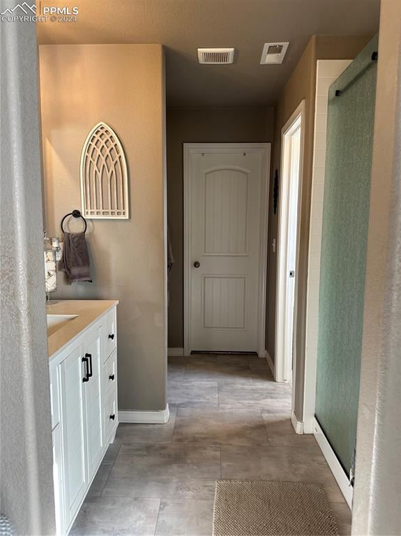 bathroom featuring vanity and a shower with shower door