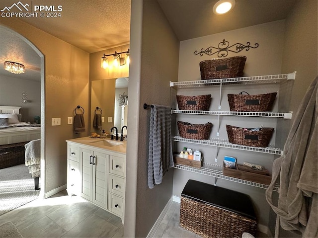 bathroom featuring vanity and a textured ceiling