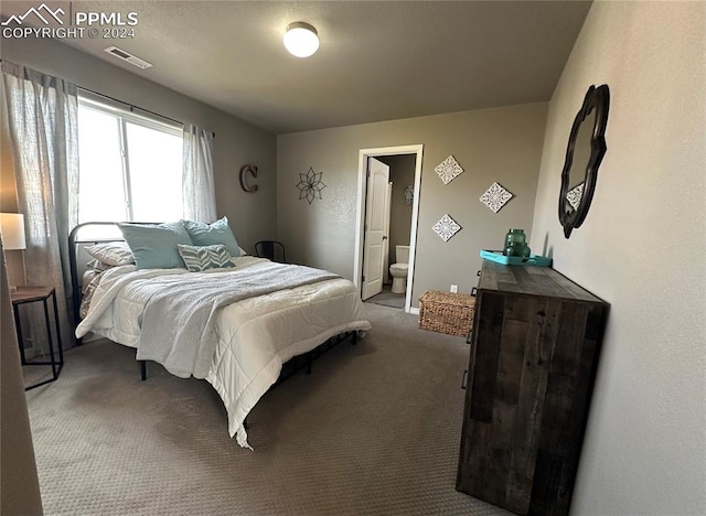 carpeted bedroom featuring ensuite bathroom