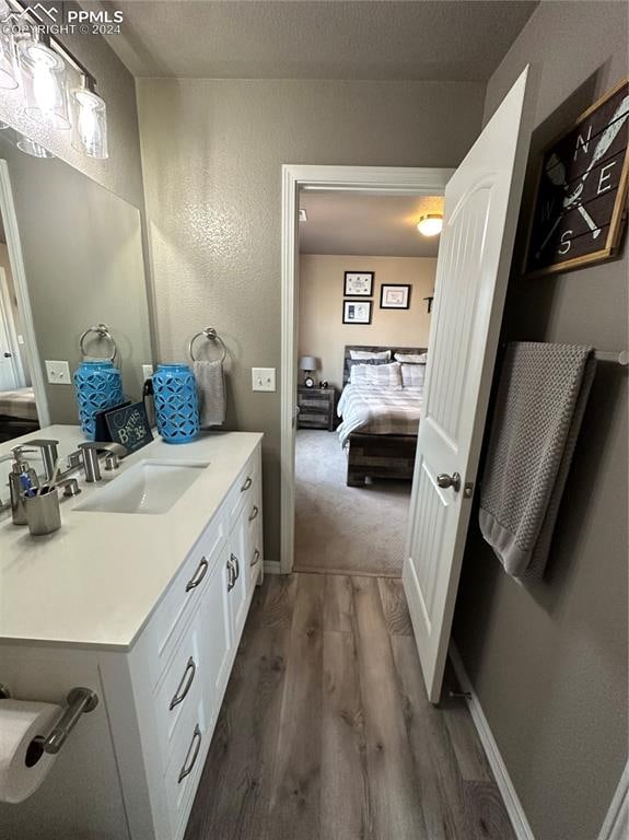 bathroom featuring vanity and wood-type flooring