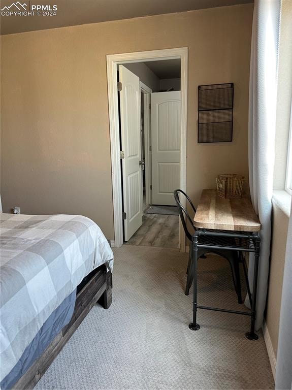 bedroom featuring light colored carpet