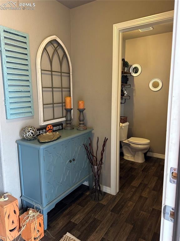 interior space featuring toilet and hardwood / wood-style flooring