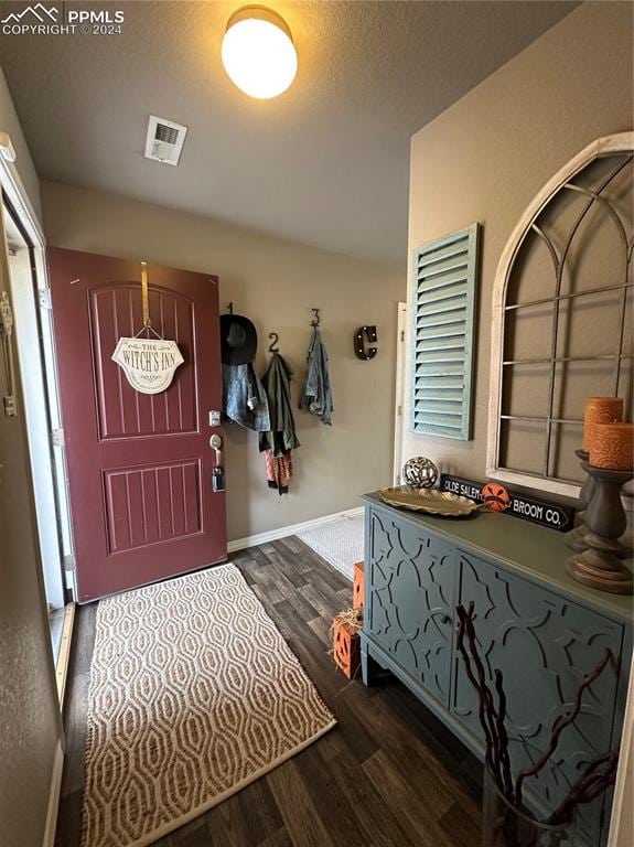 mudroom with a textured ceiling and dark hardwood / wood-style flooring